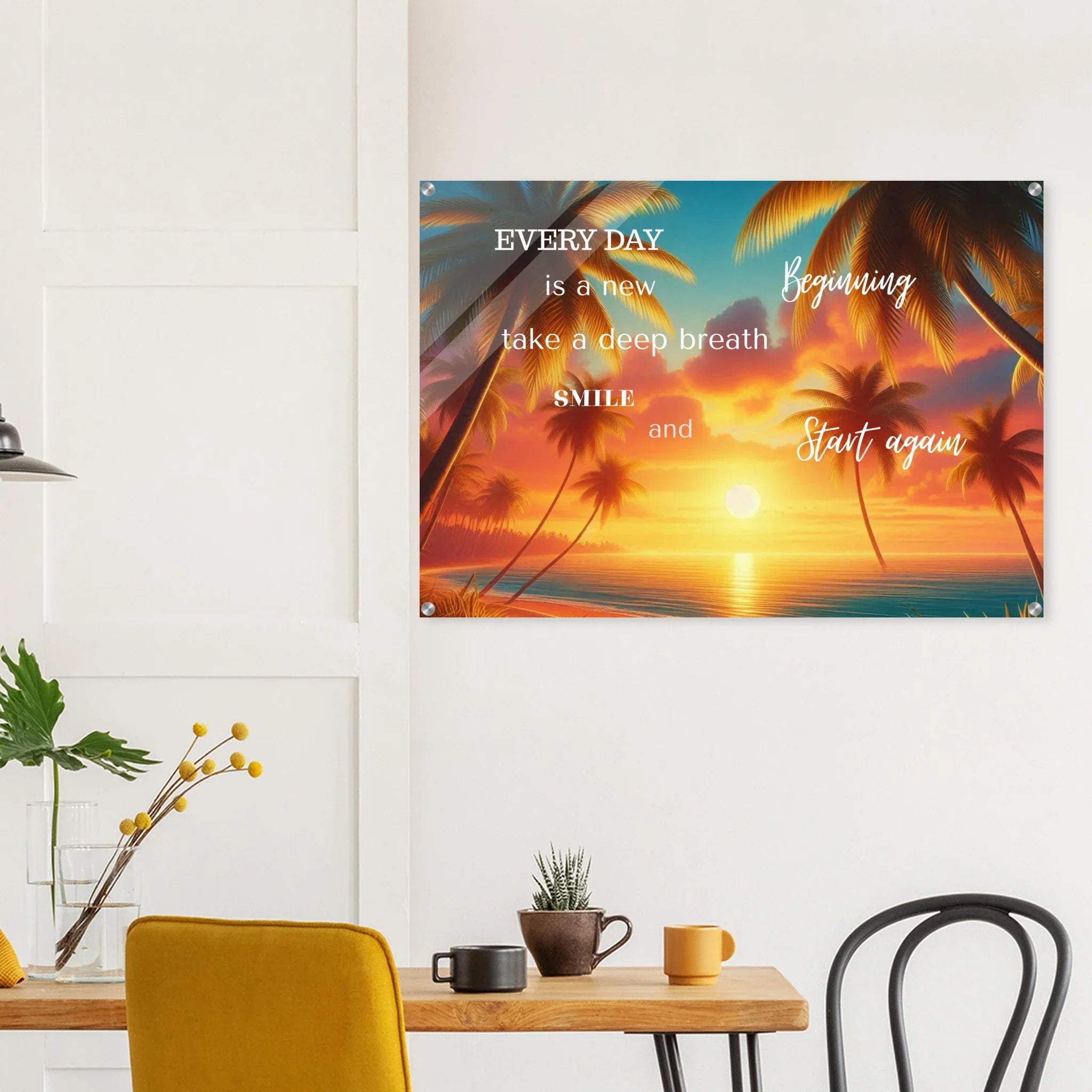 Decorative wall poster with motivational quote and sunset design in a room with a table and chairs.