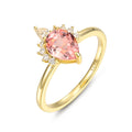925 Sterling Silver Lab Pink Sapphire Ring with pear-shaped pink sapphire and gold-plated band, size 8x6mm, adorned with small clear stones.