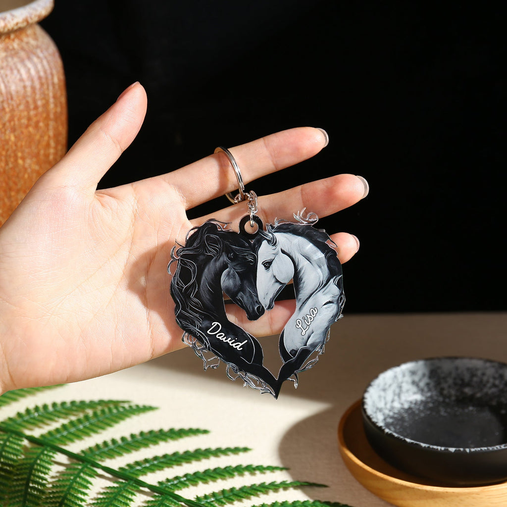 Black acrylic heart-shaped keychain featuring two intertwined horses, one black and one white, with the name "David" in.